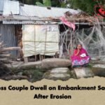 Homeless Couple Dwell on Embankment Sandbags After Erosion